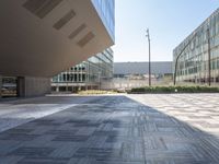 a view from inside a building of two different sized buildings, one in front of the ground and one in back