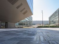 a view from inside a building of two different sized buildings, one in front of the ground and one in back