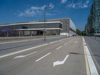 empty street with signs painted on it, on the side of a city building, in a downtown area