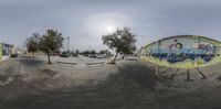 a view from inside the camera lens, of a skateboarder's park