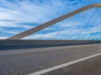 the bike is parked on the road next to the bridge with lights at its head