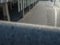 the road is empty on this busy street with the tall building in the background for pedestrians