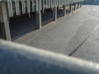 the road is empty on this busy street with the tall building in the background for pedestrians