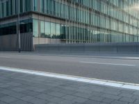 the road is empty on this busy street with the tall building in the background for pedestrians