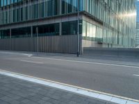 the road is empty on this busy street with the tall building in the background for pedestrians