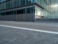 the road is empty on this busy street with the tall building in the background for pedestrians