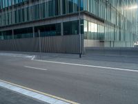 the road is empty on this busy street with the tall building in the background for pedestrians