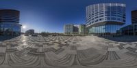 the panoramic lens on a circular picture of a large glass and concrete building