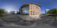 a 360 degree lens on an outside building with glass doors and plants on the side