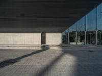 a white building next to a pool in a courtyard area with a walkway leading into it