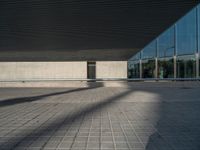 a white building next to a pool in a courtyard area with a walkway leading into it