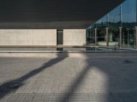 a white building next to a pool in a courtyard area with a walkway leading into it