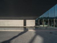 a white building next to a pool in a courtyard area with a walkway leading into it