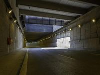 a concrete roadway has a lot of light coming from under it as if by the tunnel