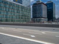 an empty street on a busy city street in japan with high buildings and skyscrapers behind it