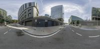 the view from a 360 - degree lens looking down the street, with traffic lights in between them