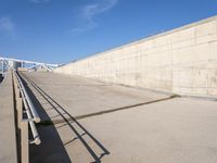 the concrete walkway is empty on a sunny day, with no people walking around it