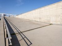 the concrete walkway is empty on a sunny day, with no people walking around it