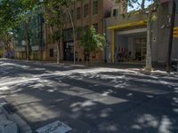 Barcelona's City Streets: Shadows and Vibrant Storefronts