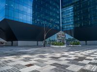 a white building next to a pool in a courtyard area with a walkway leading into it