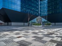 a white building next to a pool in a courtyard area with a walkway leading into it