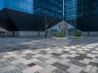 a white building next to a pool in a courtyard area with a walkway leading into it