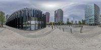 a spherical reflection picture taken from a skate park in a cityscape environment, with many buildings behind