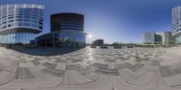 an image of some buildings taken from a fish - eye lens camera in the city