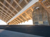 this is the underside of a bridge on a sunny day and it is not overcast, though