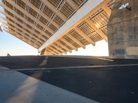 this is the underside of a bridge on a sunny day and it is not overcast, though