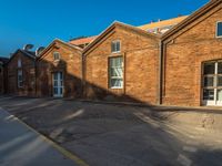 the old brick building has been cleaned and is empty of people or animals on it