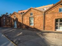 the old brick building has been cleaned and is empty of people or animals on it