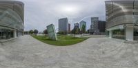 360 - views of the city skyline and square in an outside setting with lawn area