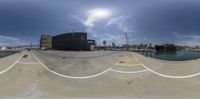 a skateboarder has captured off a ramp next to a city and harbor while he takes off