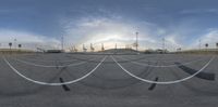 a view from below of an empty parking lot during the day with the sun setting