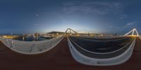 a fish eye view is seen of an area with boats and bridges and a bridge