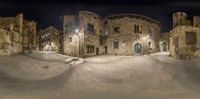 this is a panorama shot taken of a view outside a large brick building at night