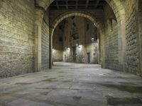 an alley way with stone floors and stone arches and an archway to the side and floor