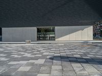 a white building next to a pool in a courtyard area with a walkway leading into it