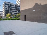 this is an empty brick walkway in the middle of a big city street near some tall buildings