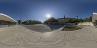 an aerial shot of a half pipe on a ramp with a blue sky above it