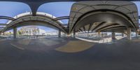 a circular perspective looking up at the skateboard park and ramps in an area full of circular buildings