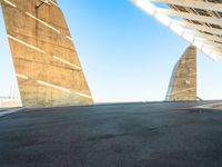 a young man in black skate board on a ramp next to building with two triangular shaped towers