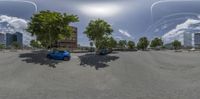 three cars in a street in a city with buildings in the background and a sky full of clouds