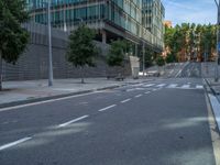 empty road next to building and traffic light in the background under a blue sky with clouds