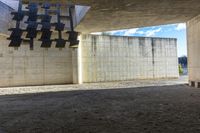 the building is made of concrete and has black and white crosses on the ceiling above