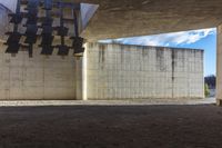 the building is made of concrete and has black and white crosses on the ceiling above