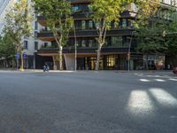 this street has two buildings and a motorcycle parked on it's side outside the building