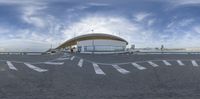 a panoramic photo showing the parking lot for the convention centre and buildings in the background