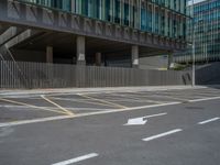 an empty parking lot with lines pointing in the opposite direction, at the end of a street